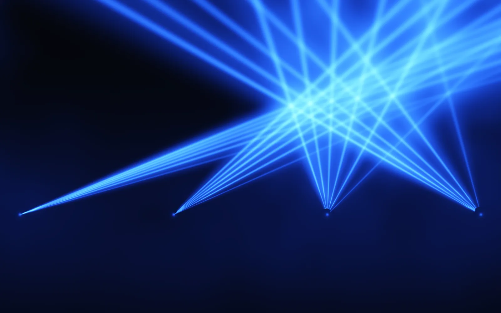 Laser: blue hairline laser beams fanning up from four emitters low on a dark stage, crossing overhead in a star-shaped formation